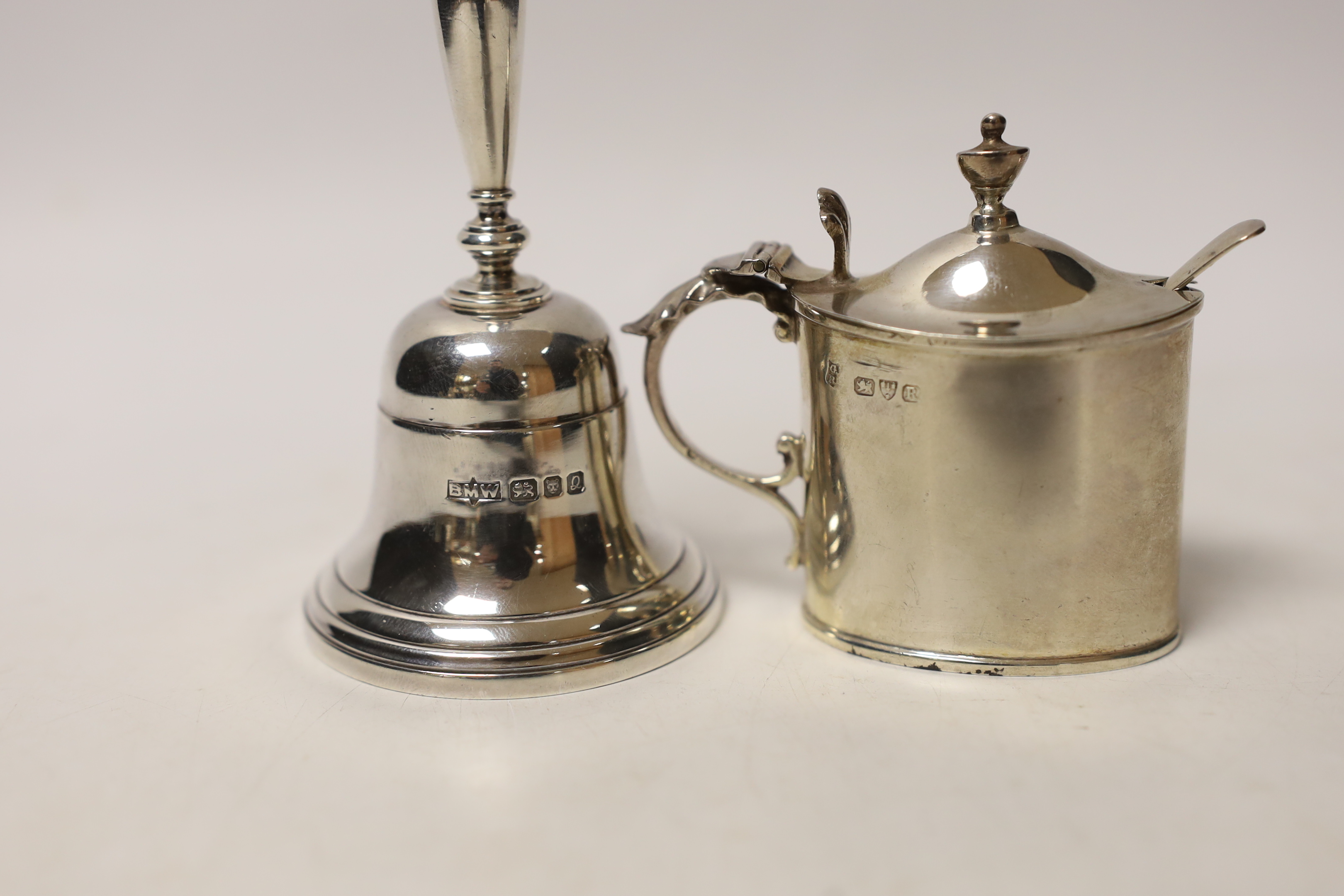 A modern silver hand bell, 10.5cm and a late Victorian silver mustard pot, Chester, 1900 and a spoon.